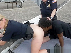 Redhead cop sucks a large dark jock