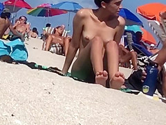 Glamorous Latin Chick showing her wet crack on bare beach