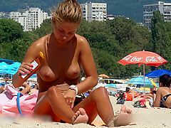 Nice looking topless beauty at the beach