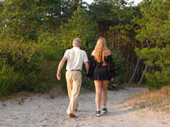 An old chap and a youthful cutie are having sex in nature