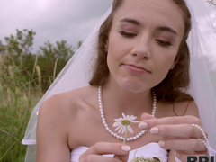 A bride in white satin underware has sex with her spouse outdoors