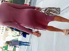 Wiggle booty tall slender dark woman in pink