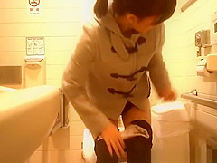 Oriental woman caught in public crapper peeing