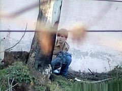 Cutie pees next to large wall