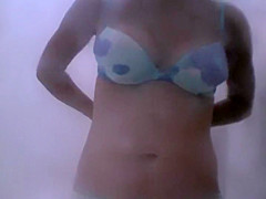 Sexy aged woman dresses after a beach