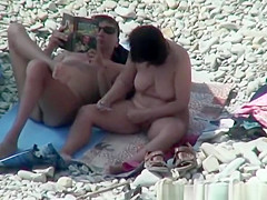 Breasty nudist woman removing pubic hairs