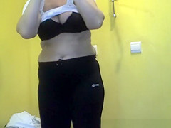 Short hair older woman undressing and dressing