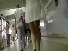 Blond woman in short white costume upskirt
