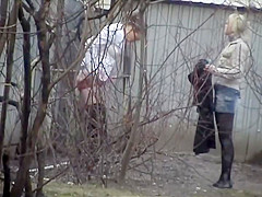 Sexy beauties void urine behind an abandoned abode