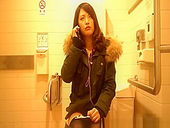 Oriental woman spied in lavatory peeing