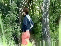 Woman looking for place to pee outdoors