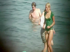 Nudist gal washes a towel in the water