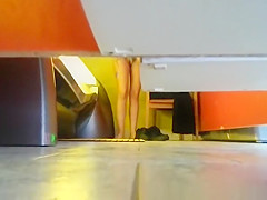 Woman undressing in tanning room