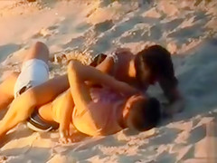 Handsome doll enjoys a dude's rod in the sand