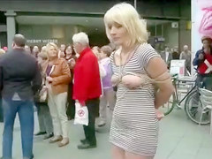 Compliant woman fastened and bare in public