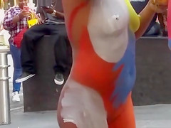 Nudist woman applies paint all over some dudes