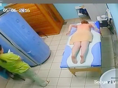 Lady with diminutive mambos disrobes in advance of a massage