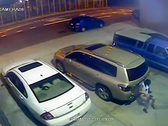 Security camera catches a cutie peeing behind a car