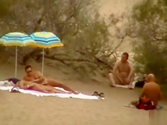 Hubby playing with her bawdy cleft in beach voyeur view