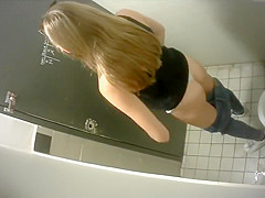 Skinny lengthy-haired brunette hair takes a quick whiz in the restroom