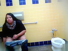 Pleasant Brazilian fattie receives recorded urinating hard in a public restroom