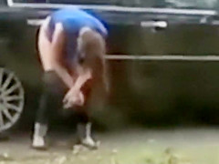 Despairing sweetheart pees on a public suburban street