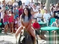 Overweight hoochie rides an electronic bull in her G-strings