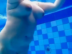Curvy stripped body floats in the pool