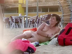 Handsome Italian woman sunbathes absolutely bare