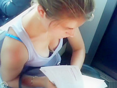 Great cleavage on a babe reading on the educate