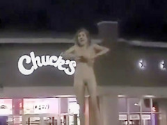 Slender exhibitionist disrobes in a fast food parking lot