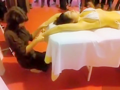Double massage in public of an Oriental bikini cutie