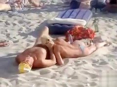 Doing the oral sex on a crowded beach