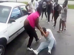 Angry dark honeys fight in a parking lot