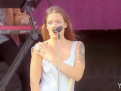 Handsome inked singer shows off one of her milk shakes at a show
