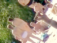 Youthful nudists take off their garments to soak up some sun on