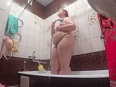 Lesbo has installed a hidden camera in the bath at his girlfriend. Peeping behind a big beautiful woman with a large booty in the shower. Voyeur.