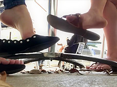 Candid flats dangling beneath table